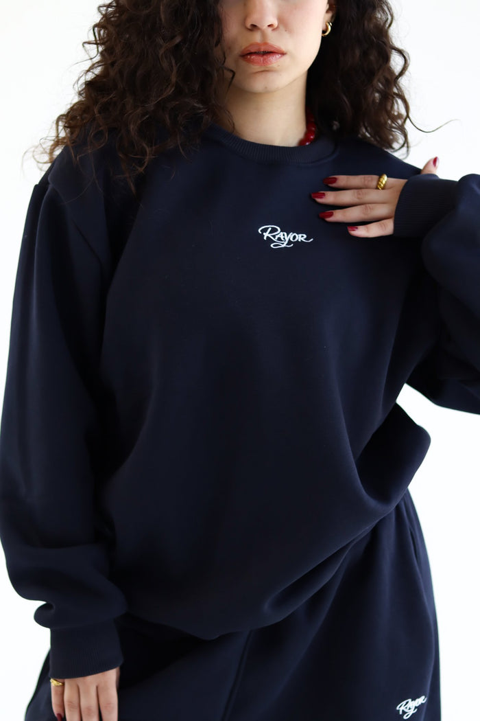 Rayor Winter Crewneck in Navy, embroidered logo detail on chest